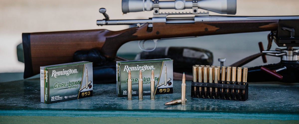Core-Lokt Tipped boxes and cartridges in front of a rifle