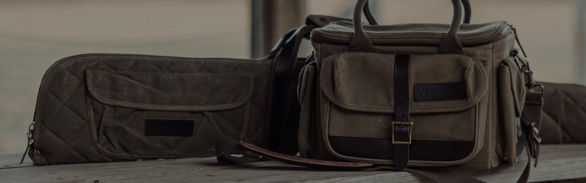 rifle case and shothsell bag sitting on a table