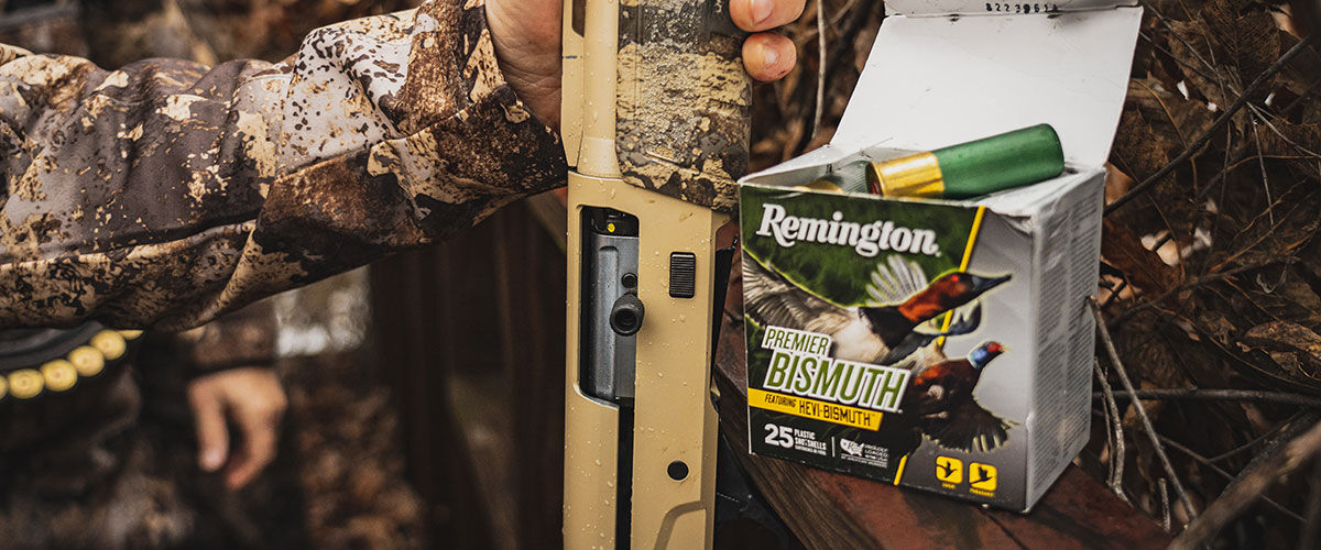 Premier Bismuth box next to a shotgun in a duck blind