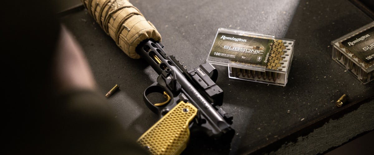 Subsonic box sitting next to a handgun on a table