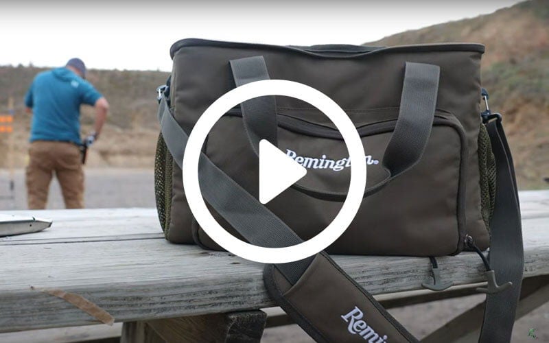 ammo bag on a table behind a shooter at a outdoor range