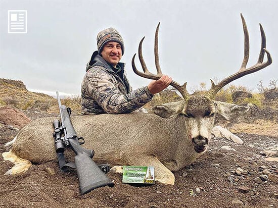 hunter beside a dead deer with his rifle and Core-Lokt Tipped ammunition packaging
