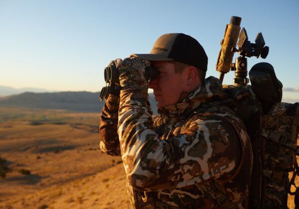 hunter looking through binoculars