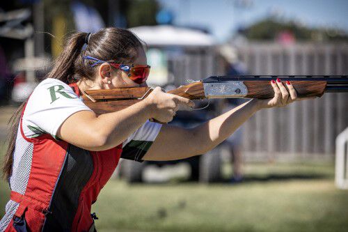 Reanna Frauens aiming a shotgun