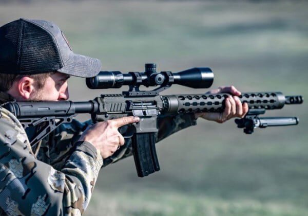 shooter looking down the scope of a rifle