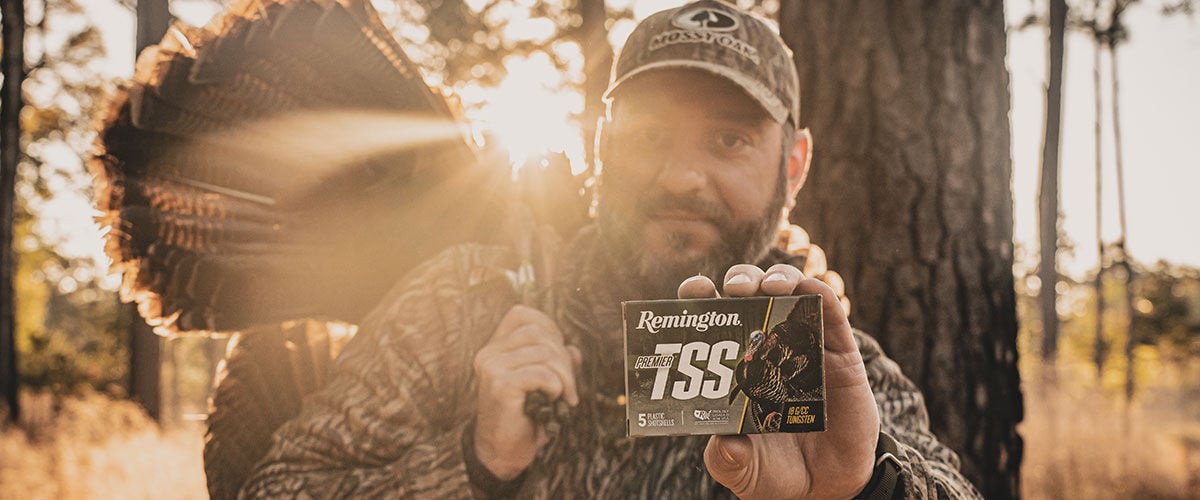 hunter holding turkey and box of Premier TSS