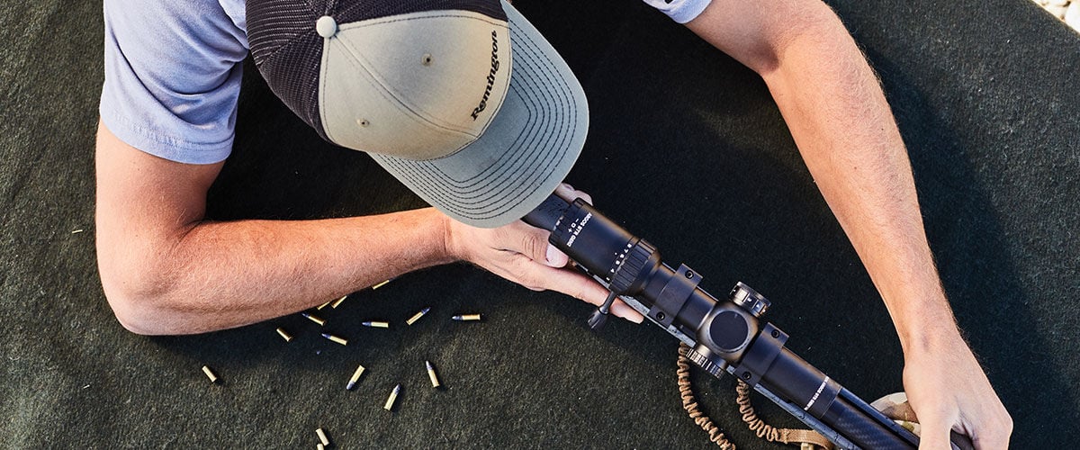 shooter in a prone position aiming rifle