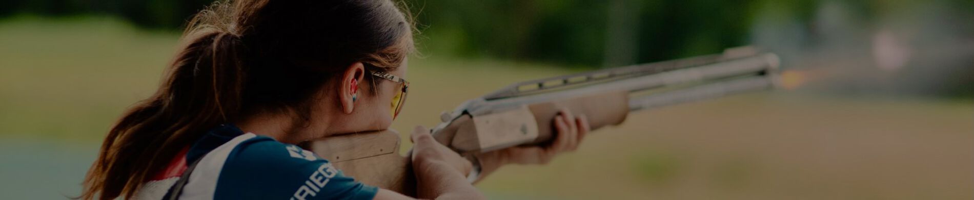 Julia Stallings aiming a shotgun