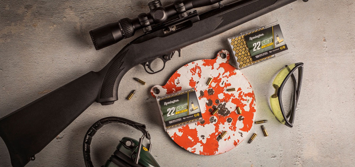 rifle with a shot target, eye and ear protection, and 22 Target ammo