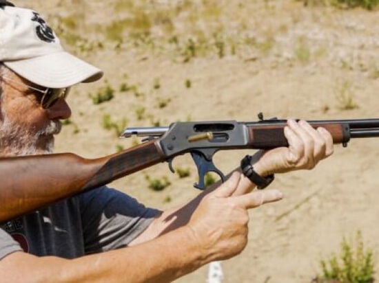 shooter reloading a Henry rifle