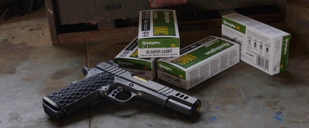 handgun laying next to a couple boxes of UMC 30 Super Carry