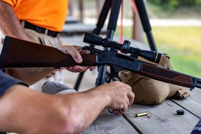 lever action rifle with an ejected Core-Lokt 360 buckhammer on a table