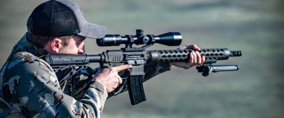 shooter looking down the scope of a rifle