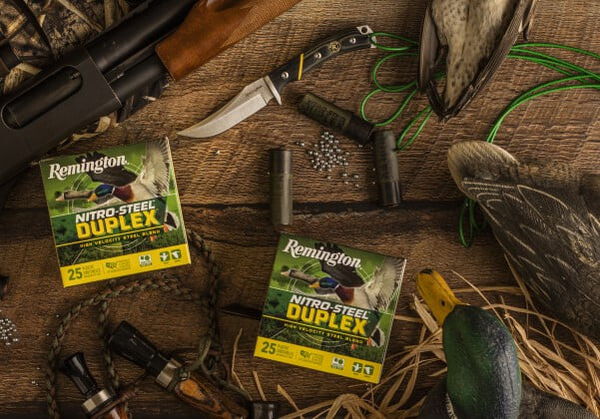 Nitro-Steel Duplex packaging, calls, decoys, shotgun, shotshell, and knives on a table