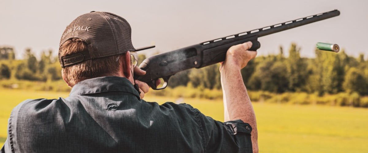 shooter looking down the iron sights of a shotgun