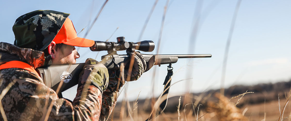 hunter aiming a rifle