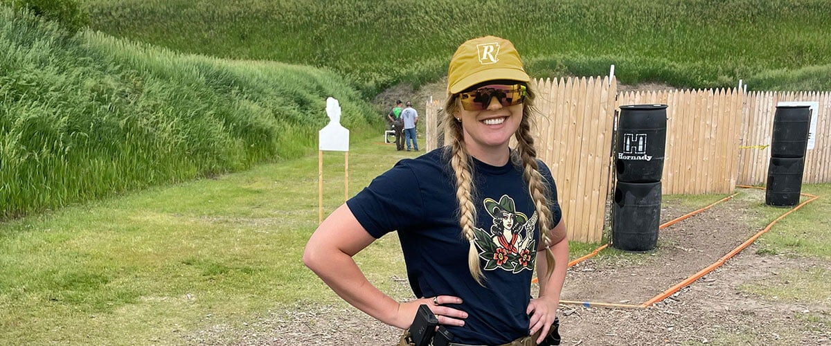 Audrey Mayes standing on a 3 gun course