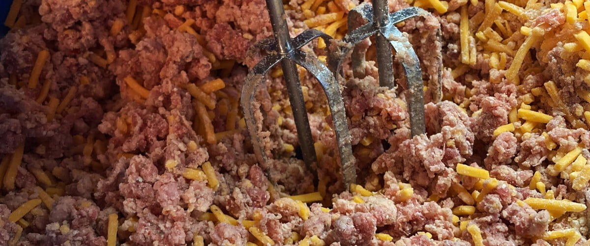 blender mixing sausage and shredded chedder cheese