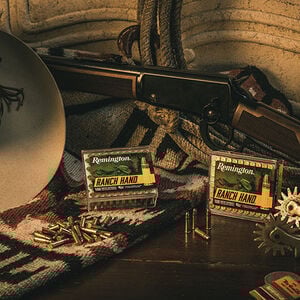 Ranch Hand packaging sitting around a cowboy hat and lever action rifle
