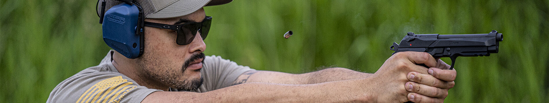 Man firing handgun outside