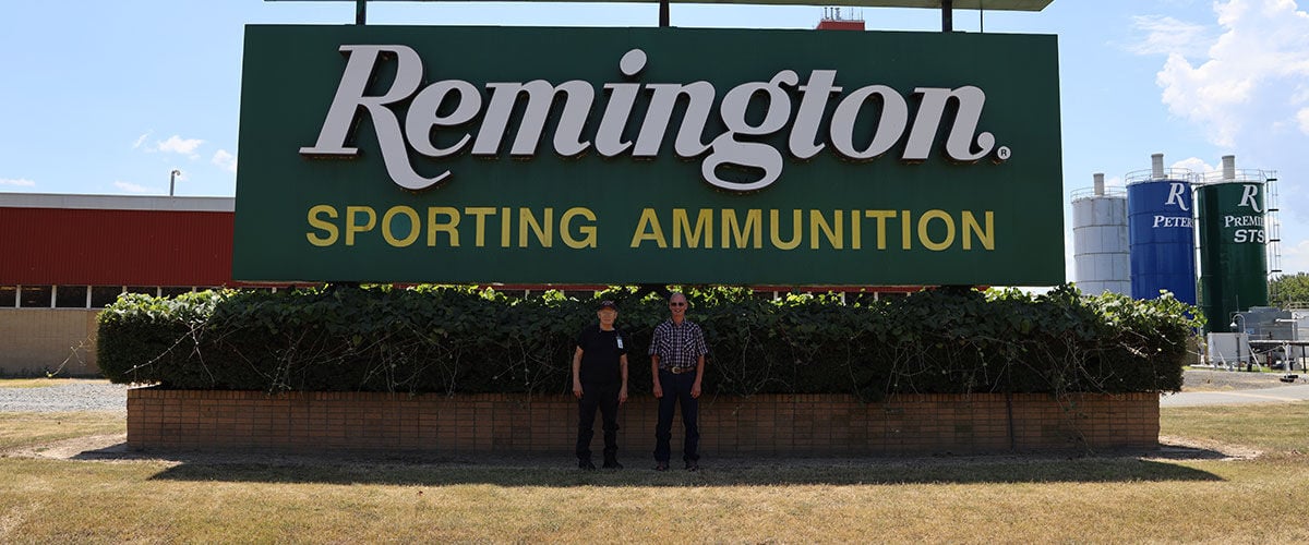 John and James in front of the Remington sign