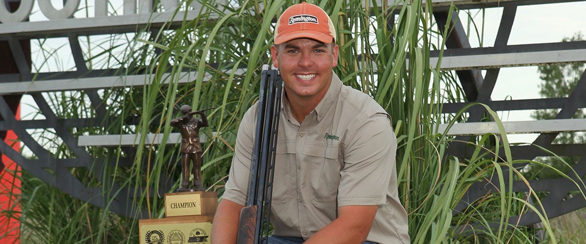 shooter next to his trophy
