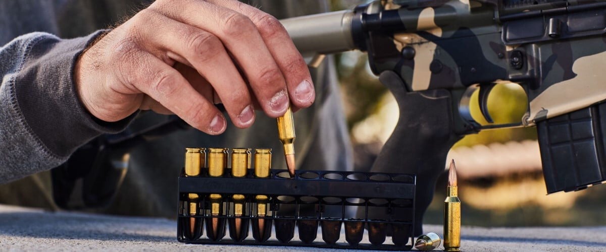 shooter pulling cartridge from ammo insert