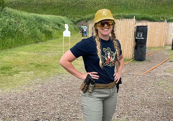 Audrey Mayes standing in front of an outdoor range