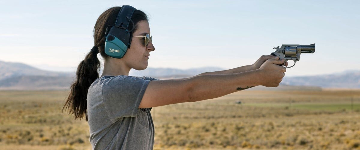 woman aiming handgun