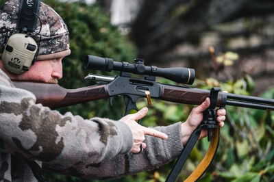 Hunter shooting lever action rifle