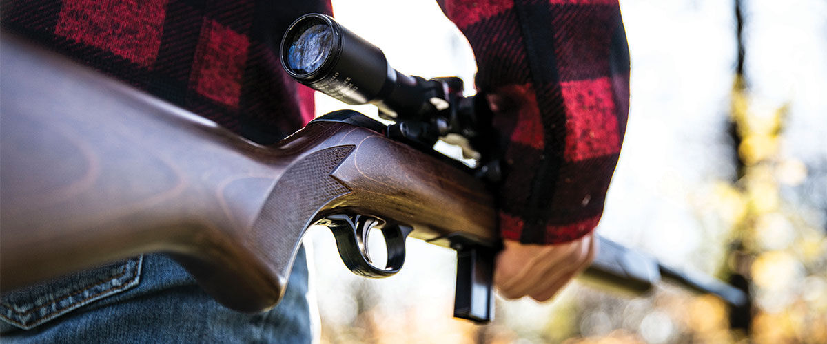 person carrying a rifle