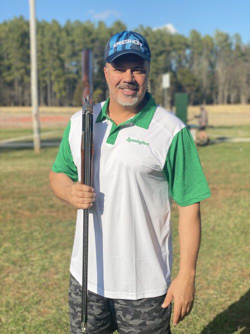 Alessandro Vitale standing with his shotgun on his shoulder