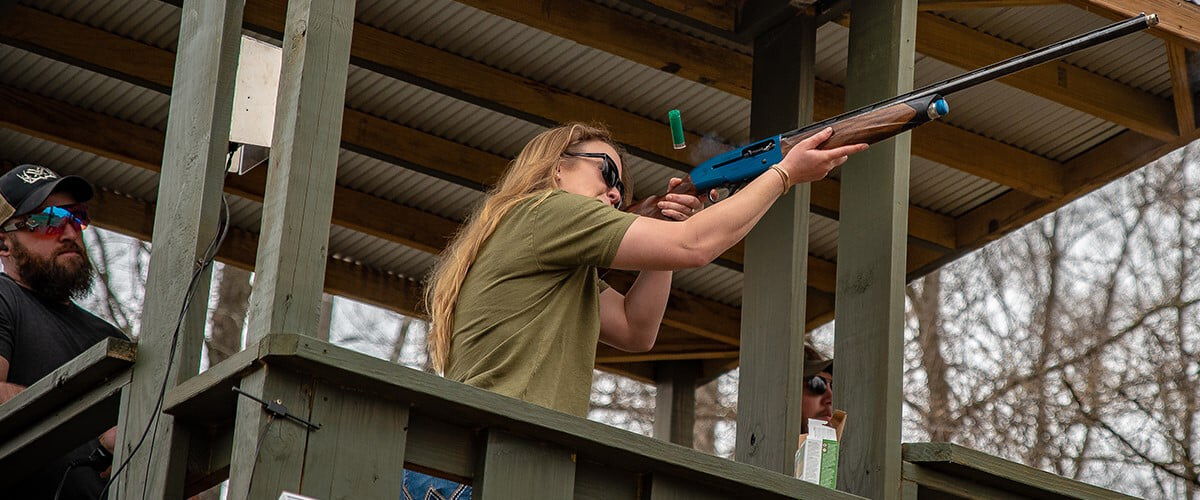 shooter aiming shotgun at a range stall