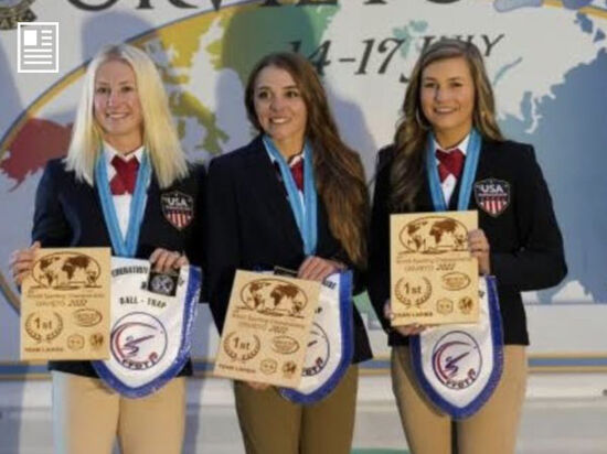 3 members of team remington holding up there awards