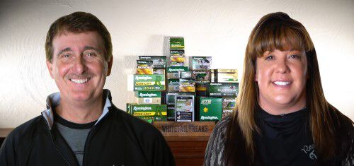 Don and Kandi in front of stacked Remington ammunition