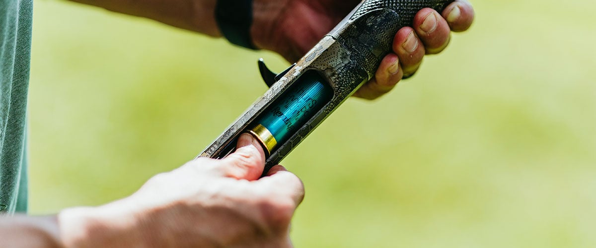 Remington shotshell being loaded into a shotgun