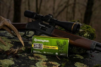 Core-Lokt 360 Buckhammer box laying on a mossy rock with a rifle and a deer antler close-up