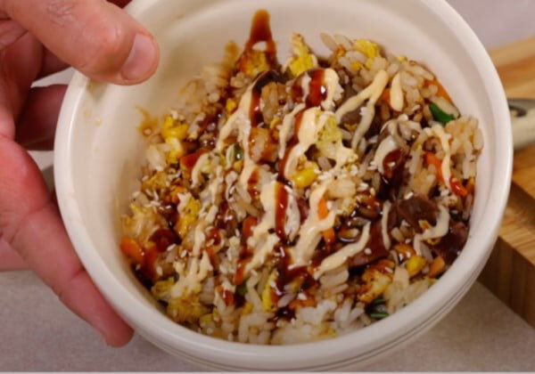 duck fried rice in a bowl with sauces