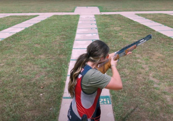 Julia Stallings aiming a shotgun