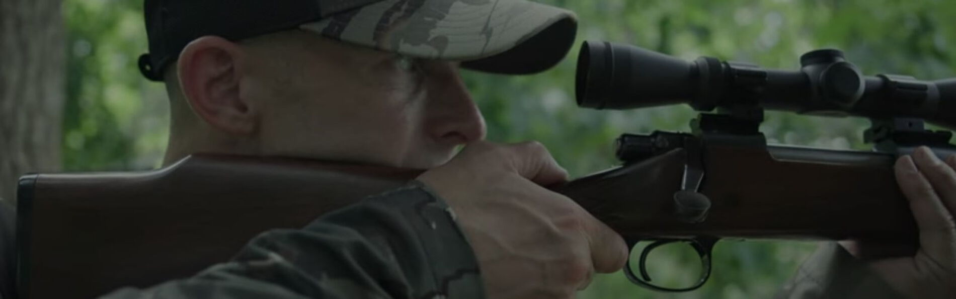 Matt Hewett looking down the scope of a rifle