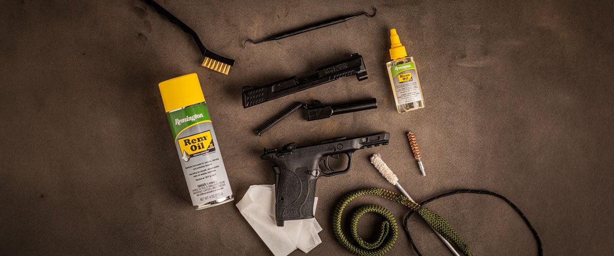 Handgun surrounded by cleaning accessories