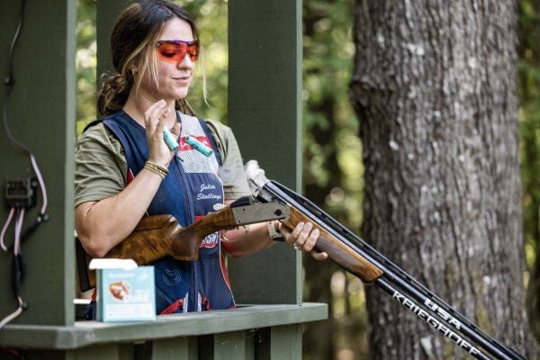 Julia Stallings catching 2 ejected shotshells from her shotgun