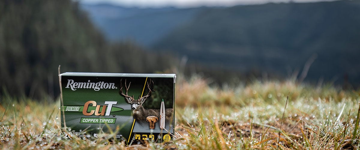 Premier CuT box in the grass with mountains in the background