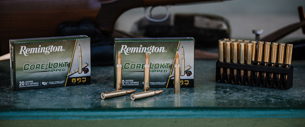 Core-Lokt Tipped boxes and cartridges in front of a rifle