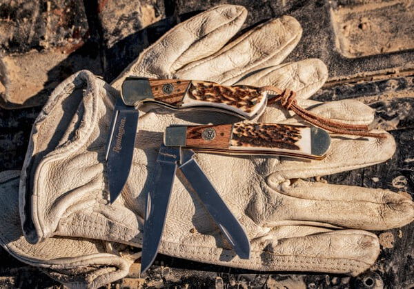 two Remington knives sitting on a pair of gloves