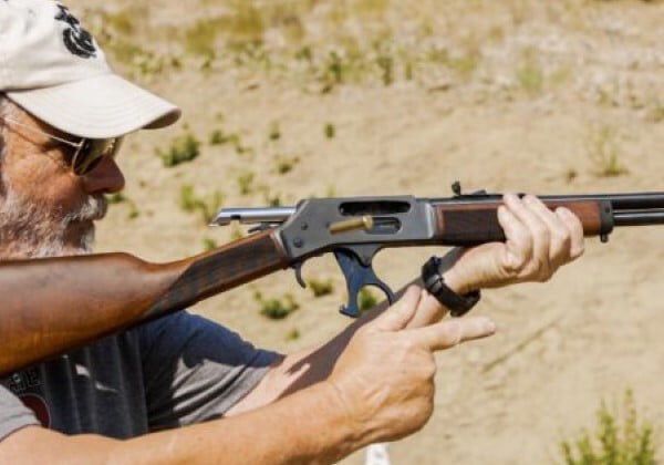 shooter reloading a Henry rifle