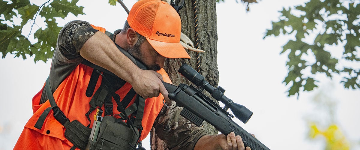 hunter aiming through a rifle scope