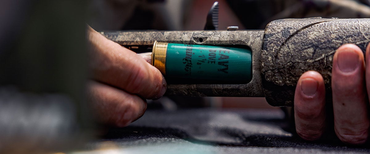 Remington shotshell being loaded into a shotgun