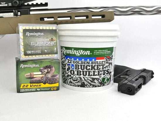 Remington Subsonic, 22 Viper, and 22 Golden Bullet package on a table next to a handgun