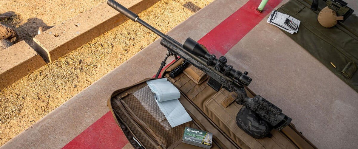 rifle sitting on cement at an outdoor range with a box of Core-Lokt Tipped